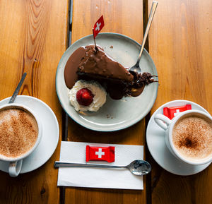 Swiss chocolate cake with 2 cups of cappuccino 