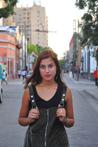 Portrait of beautiful woman standing on street in city