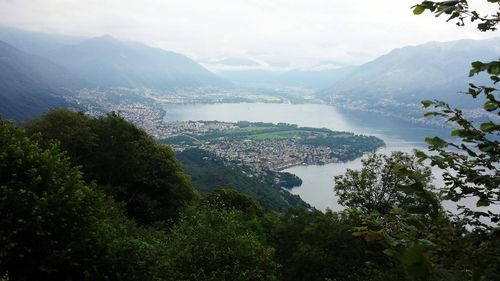 High angle view of lake and mountains against sky