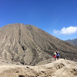 Rear view of man standing on mountain