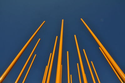 Low angle view of metallic structure against blue sky