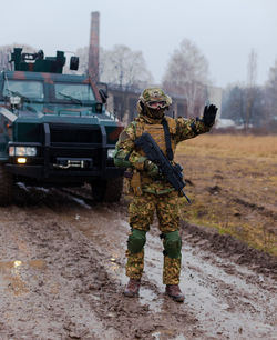 Soldier stops the car with a machine gun in his hands