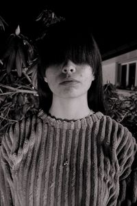 Portrait of young woman standing outdoors