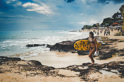 People on beach against sky