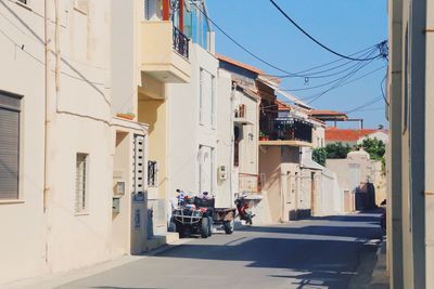 People on street amidst buildings in city