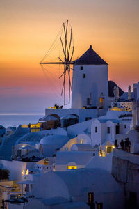 Houses by sea during sunset at santorini