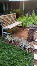 Empty chairs and table in yard