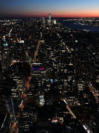 Aerial view of city lit up at night