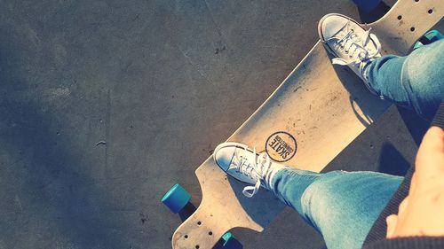 Low section of man standing on skateboard