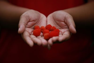 Close-up of hand holding strawberries