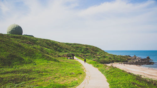Scenic view of landscape against cloudy sky