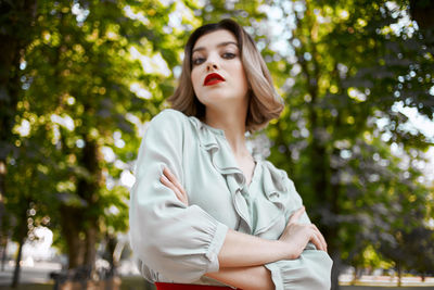 Portrait of a beautiful young woman against trees