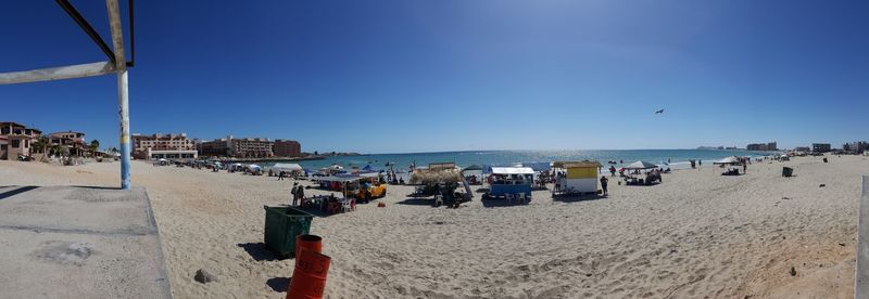 Panoramic view of beach against clear blue sky