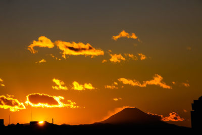 Scenic view of silhouette mountains against sky during sunset