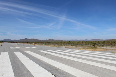 Surface level of road against blue sky