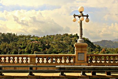 Railing against cloudy sky