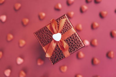 Red gift box on the background of hearts for valentine's day