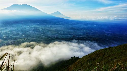 Scenic view of sea and mountains against sky