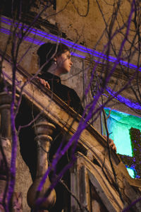 Woman standing against graffiti wall