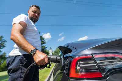 Low section of man holding car