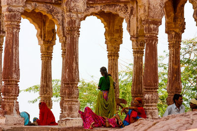 People sitting at historical building