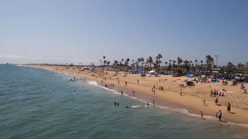 People on beach against sky