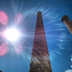 Low angle view of tower against blue sky