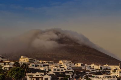 High angle shot of townscape against clouds