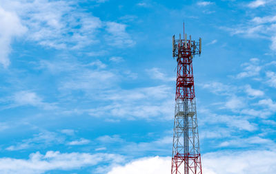 Telecommunication tower with blue sky and white clouds background. antenna on blue sky. 