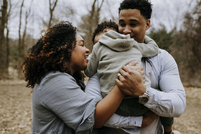 Parents with son enjoying in forest