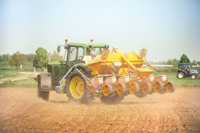 Tractor on agricultural field against sky