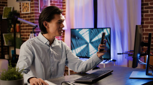 Businesswoman having video call on smart phone in office