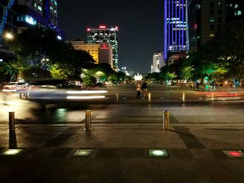 Illuminated city street and buildings at night