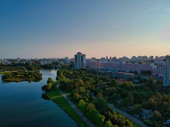 High angle view of river and buildings against clear sky
