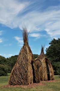 Hay bales on field against sky