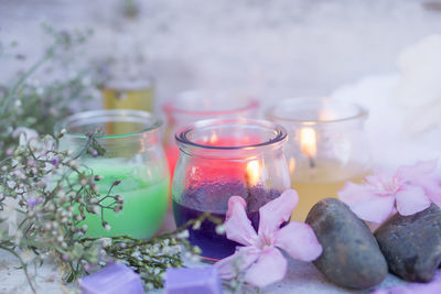 Close-up of flowers in glass container on table