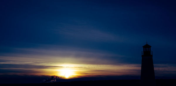 Silhouette building against sky during sunset