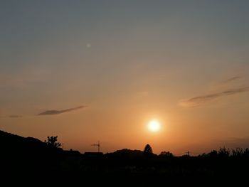 Scenic view of silhouette field against romantic sky at sunset