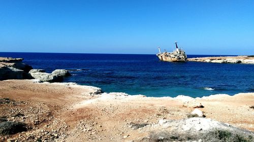 Scenic view of sea against clear blue sky