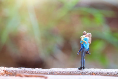 Close-up of figurine standing outdoors