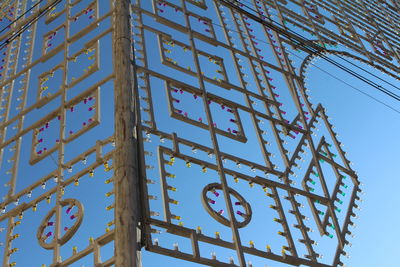 Low angle view of sign against clear blue sky