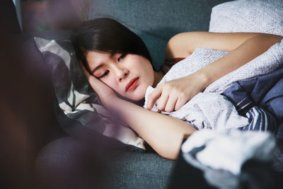 Portrait of a girl sleeping on bed at home