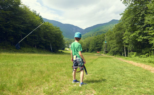 Full length of boy standing on field