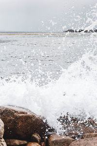 Scenic view of sea waves splashing on shore