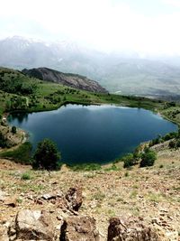 Scenic view of lake and mountains against sky