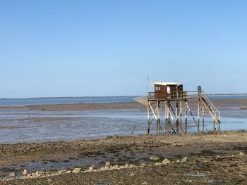 Lifeguard hut on beach against clear sky