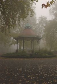 Gazebo by trees against sky