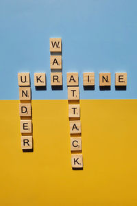 A lot of yellow stickers with words on blue background. concept of  support. stop war in ukraine