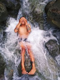 High angle view of man looking at waterfall