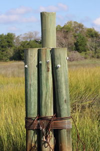 Wooden fence on field against sky